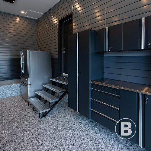 alt="beautiful resurfaced garage with polyaspartic and storage solutions"