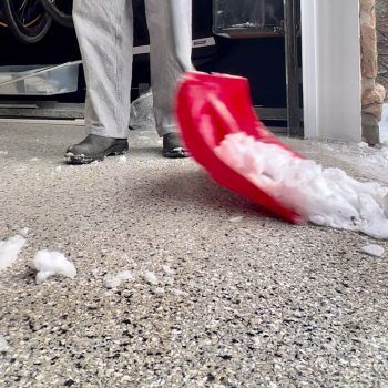 Shovel on driveway concrete coating polyaspartic floor alt=“Shovel ice off sealed concrete driveway without metal tools”