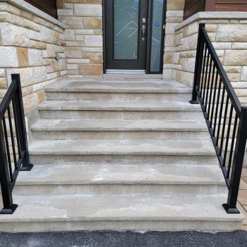 Stairs damaged by winter alt="Outdoor concrete stairs worn by freeze-thaw cycles."