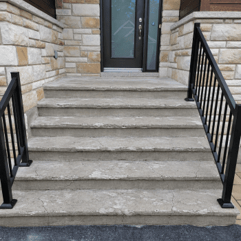 Damaged outdoor steps alt="Damaged outdoor concrete steps in front of a home."