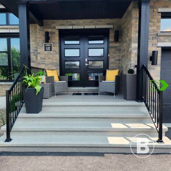 Renovated exterior entrance alt="Exterior entrance with steps covered in a light coating."