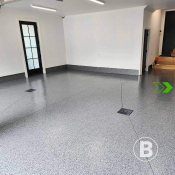 Garage with flake floor coating alt="Garage with grey flake floor coating."