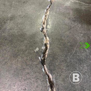 Crack in concrete alt="Visible crack in a concrete slab."