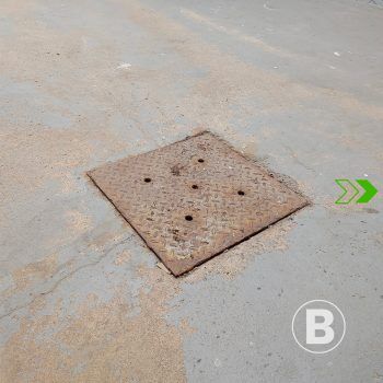 Worn concrete slab alt="Worn concrete slab with stains and dust."