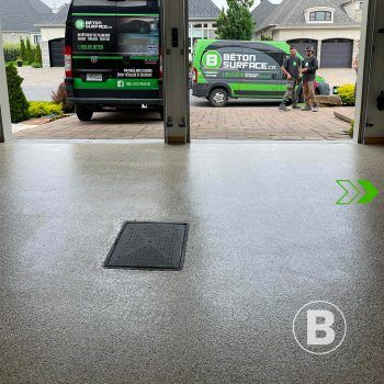 Renovated garage with durable coating alt="Renovated garage floor with grey flake coating."