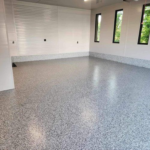 alt="polyaspartic floor with vinyl flakes in garage"